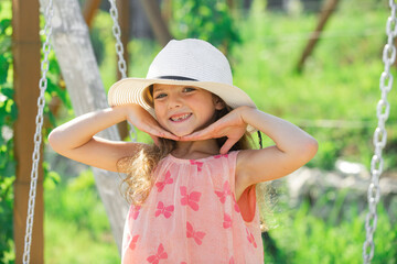 Adorable little girl portrait closeup outdoors in summer. Summer vacation and happy childhood. Emotional portrait of a cheerful and positive smiling teen girl.