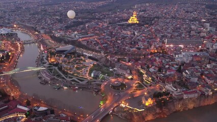 Wall Mural - Scenic aerial view at twilight of Tbilisi cityscape overlooking illuminated Church of Holy Trinity, Georgia