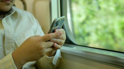 Canvas Print - A man in a commuter train subway metro traveling and uses the smartphone happy tourist travel by train  Freedom trip on vacation time holiday weekend