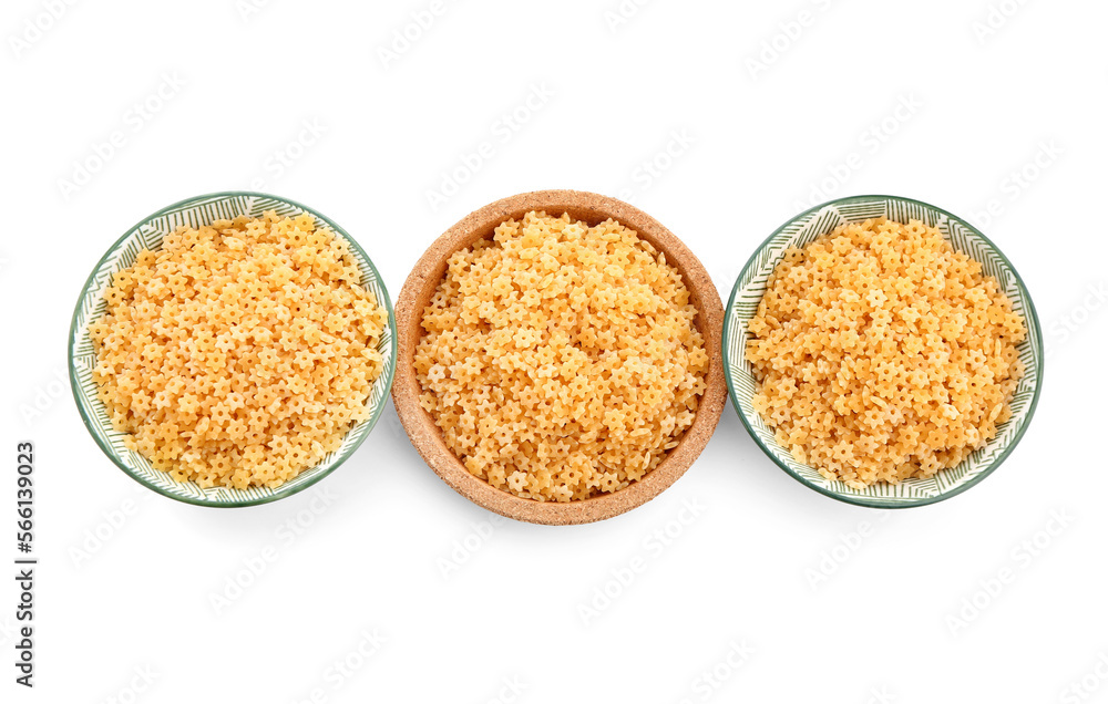 Bowls of raw stelline pasta isolated on white background