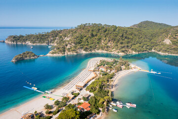 Fototapete - Turkey, scenic beach with white sand surrounded blue sea. Mediterranean waters near turkish coasline. Beautiful aerial view on beach of Oludeniz town. 