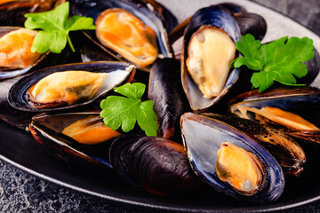 Wall Mural - Delicious seafood mussels with sauce and parsley.