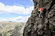 © Westend61 - Man wearing backpack climbing on mountain, Lake District, England