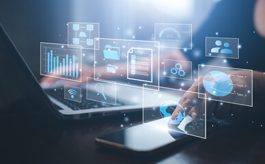 Businessman working on laptop and touch screen Online documentation database, IT consultant being set up Virtual Document Management System with laptop,Software for archiving corporate files.