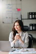 © Nuttapong punna - Asian businesswoman working in the office with working notepad, tablet and laptop documents