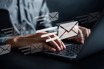 Businessman sending email by laptop computer to customer, business contact and communication, email icon, email marketing concept, send e-mail or newsletter, online working internet network.