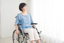 家で車椅子に乗る障がい者女性