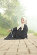 © Hadi - woman in black dress and white hijab