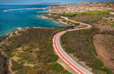 Wall Mural - Beautiful European sea coast and empty curved road in summer time. View of the road along the coast from the drone. Travel by car concept