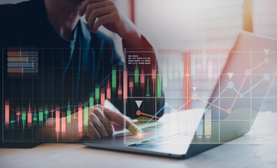 Businessman trading online stock market on computer laptop with vitual trading graph screen, digital investment concept, investment plans and strategy.