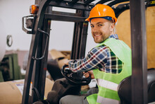 Man Working At Warehouse And Driving Forklift