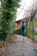 © Cultura Creative - Athletic woman jogging on footpath
