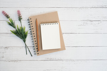 Wall Mural - Flat lay, Top view text and leave a message concept on vintage white wooden table desk background with stack blank notepad and green plant,  stationeries, copy space