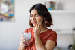 © Prostock-studio - Sensitive Teeth. Young arab woman drinking water with ice and touching cheek