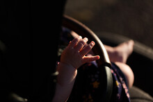 Detail Of Baby Hand While Walking In Pram Sunlit By Afternoon Light