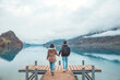 © oatawa - Travelers couple look at the mountain lake in Iseltwald jetty at Lake Brienz in Switzerland, Travel and active life concept