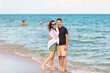 © travnikovstudio - Young couple on white beach during summer vacation.