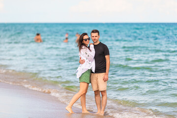 Wall Mural - Young couple on white beach during summer vacation.