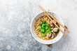 Asian vegan miso ramen noodle soup with mushrooms, onions and cilantro