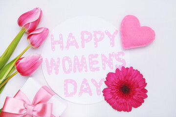 Wall Mural - Gerbera and tulips flowers, felt heart, gift and roundcard with text 8 Happy Women's Day on white background