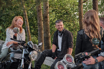 Wall Mural - A company of friends travel together on motorcycles, stopped at the roadside, have fun and drink tea