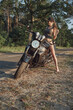© perfectlab - Young sexy woman biker in bikini sitting on a motorcycle on the side of a forest road