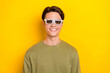 © deagreez - Photo of optimistic cheerful man wear khaki clothes watching interesting film isolated on yellow color background