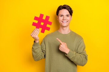 Wall Mural - Photo of attractive glad man influencer arm direct empty space share news information social media post isolated on yellow color background