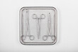 Surgical instruments in a tray on a white