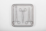 Fototapeta  - Surgical instruments in a tray on a white