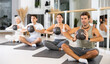 © JackF - Sporty men and women doing pilates exercises with fitness ball at gym