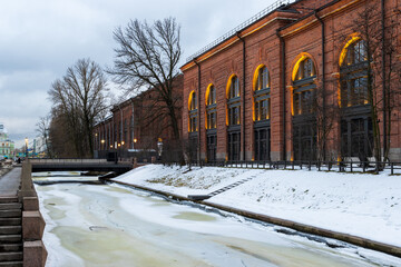 Wall Mural - Winter cityscape. View of the building on the island of New Holland in the city of St. Petersburg. Ice floes on the Kryukov Canal. Historic city center of Saint Petersburg, Russia. Cold winter weather