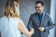© Dragana Gordic - Sealing a deal! Two Business people shaking hands after Welcoming partners finishing up a meeting or setting goals and planning way to success in the office.