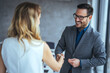 © Dragana Gordic - Portrait of cheerful young manager handshake with new employee. Close up of handshake in the office. Smiling businessman shaking hands while standing in an office. Handshake for the new agreement