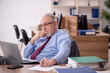 © Elnur - Old male boss employee working in the office