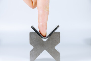 Wall Mural - Equipment for bending sheet metal on a CNC bending machine on a white background. A man's finger bends a metal part. Bending concept.