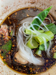 Wall Mural - Thai Boat noodles served with vegetable and thicken soup with stewed pork , pork ball ,Braised pork and liver pork. Thai food concept.