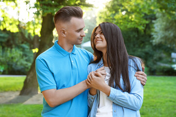 Wall Mural - Happy young couple having good time together in park