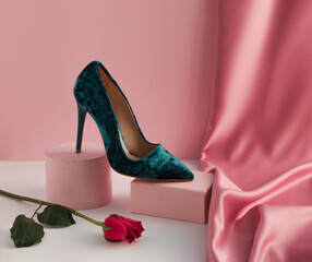 Modern aesthetic composition with elegant woman's shoe on product podium, rose flower and pastel pink silk curtain. Valentine's Day or 8 March beauty concept.