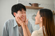© bongkarn - Happy Asian girl touching her boyfriend's face with love, laughing and making fun