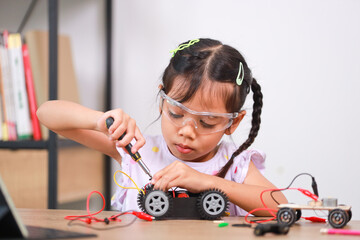 asian little girl students learn at home by coding robot cars in stem, steam, mathematics engineerin