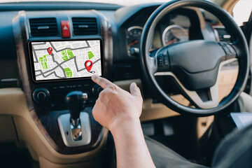 Canvas Print - A man makes use of GPS and the internet. online map in the car controls the navigator for GPS tracking.