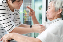Angry Asian Senior Grandmother Scolding Woman,Aggressive Old Elderly People Shouting Pointing Finger At Frightened Female Caregiver,dissatisfaction Irritated,violence Aggression,mental Health Concept