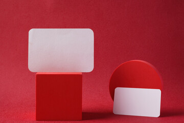 Poster - mockup business card paper with pedestal on red background