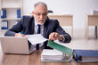 © Elnur - Old male employee working in the office