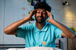 © WESTOCK - Young man suffering headache pain during midnight at home - concept of health care, stress and unhappy.