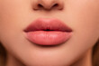 Beautiful lips Close-up. Makeup. Lip matte lipstick. Sexy lips. Part of face, young woman close up. perfect plump lips bodily lipstick.  peach color of lipstick on large lips. Perfect makeup.   