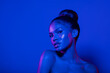 Fashion portrait model in colorful bright lights with trendy makeup posing in studio.Closeup African American woman in blue and pink lighting filters with copy space 
