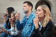 © New Africa - People smoking cigarettes at public place outdoors