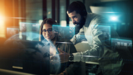 Aufkleber - Businessman, woman and computer with overlay in night for planning, crm and coaching in futuristic office. Tech support coach, man and girl by pc for learning, 3d holographic abstract and teamwork